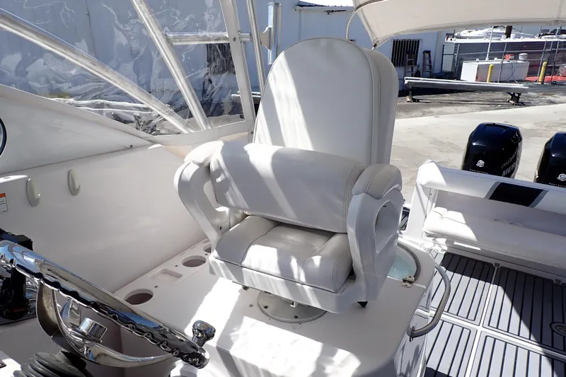 Slide: The Image of Captain's chair on 2014 Pro-Line 32 Express boat, featuring sleek design and modern controls. - 8