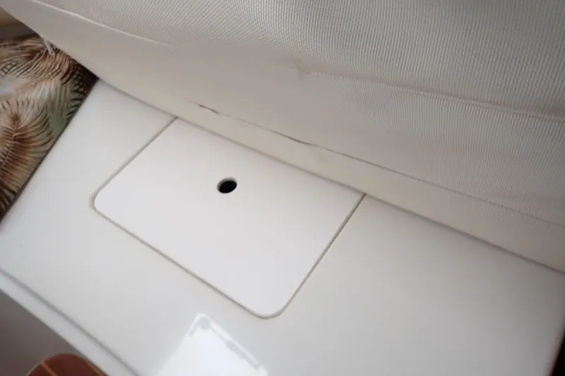 Slide: The Image of Interior seating and storage compartment on a 2014 Pro-Line 32 Express boat. - 80
