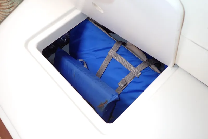 Slide: The Image of Storage compartment on 2014 Pro-Line 32 Express boat with blue life jackets. - 81