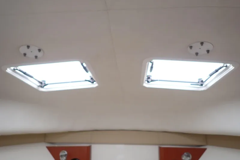 Slide: The Image of Interior view of 2014 Pro-Line 32 Express boat with two ceiling hatches. - 82