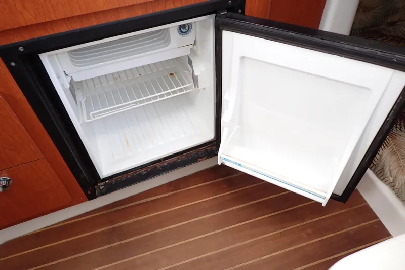 Slide: The Image of Open refrigerator on 2014 Pro-Line 32 Express boat with wooden flooring. - 88