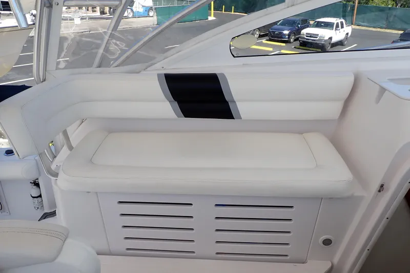 Slide: The Image of White seating area on 2014 Pro-Line 32 Express boat, featuring sleek design and comfortable cushions. - 9