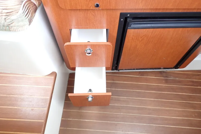 Slide: The Image of Wooden drawers and cabinet in 2014 Pro-Line 32 Express boat interior. - 91