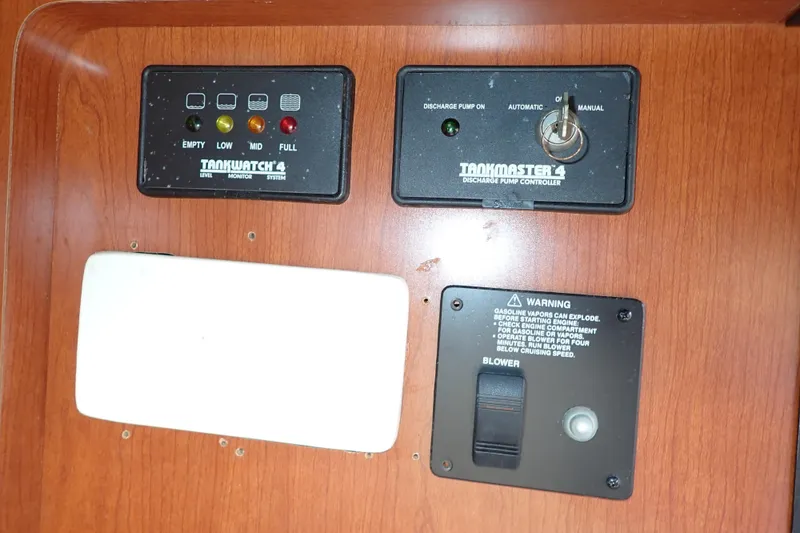 Slide: The Image of Control panel of a 2014 Pro-Line 32 Express boat with tank monitor and pump controller. - 95