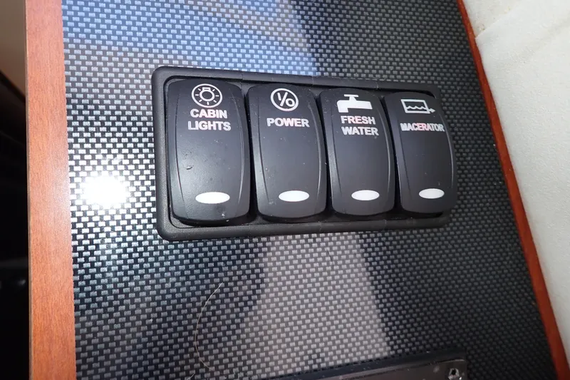 Slide: The Image of Control panel on 2014 Pro-Line 32 Express boat with labeled switches. - 97