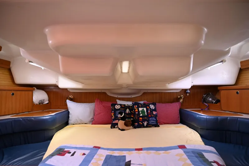Slide: The Image of Cozy cabin interior of 2002 Catalina 400 MkII sailboat with colorful bedding and pillows. - 10