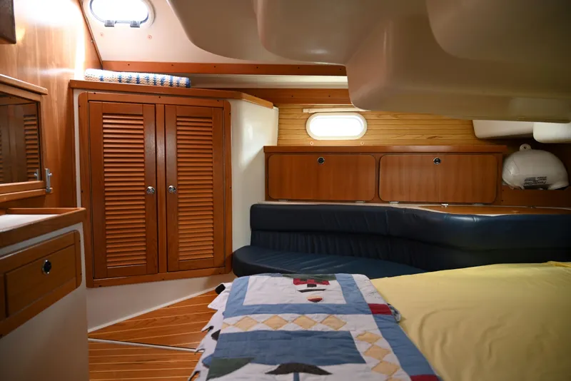 Slide: The Image of Luxurious interior of a 2002 Catalina 400 MkII sailboat with wood finishes and cozy seating. - 13