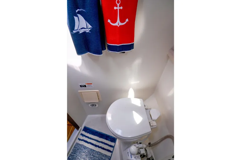 Slide: The Image of Nautical-themed bathroom in 2002 Catalina 400 MkII sailboat with anchor and sailboat towels. - 14