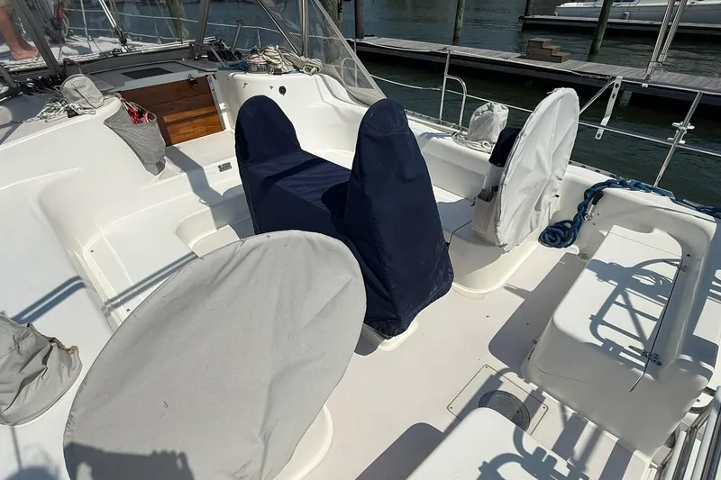 Slide: The Image of 2002 Catalina 400 MkII sailboat cockpit with covered seating and helm, docked at marina. - 18