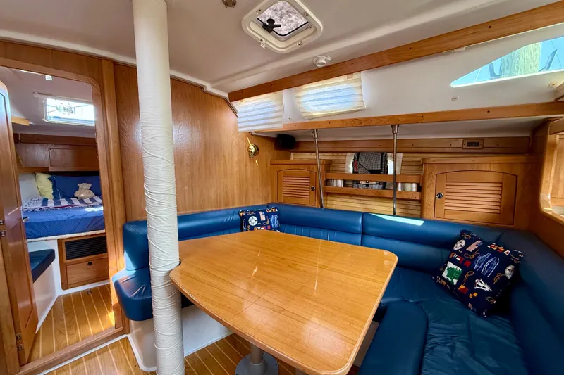Slide: The Image of Interior of 2002 Catalina 400 MkII sailboat with wooden finishes and blue seating. - 30