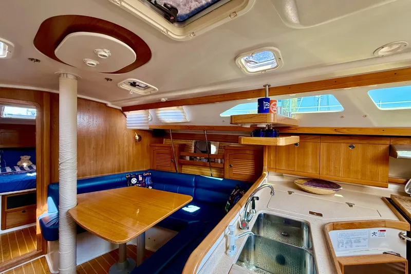 Slide: The Image of Interior of 2002 Catalina 400 MkII sailboat with cozy dining area and kitchen. - 31