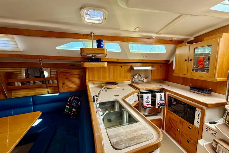 Slide: The Image of Interior of 2002 Catalina 400 MkII sailboat with wooden cabinetry and modern amenities. - 34