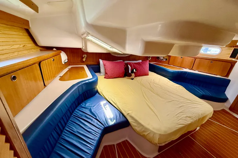 Slide: The Image of Cozy cabin interior of 2002 Catalina 400 MkII sailboat with plush bedding and wood accents. - 37