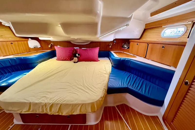 Slide: The Image of Luxurious cabin interior of 2002 Catalina 400 MkII sailboat with cozy bedding and wood accents. - 38