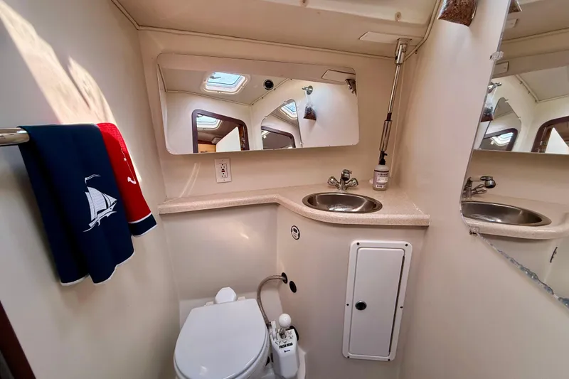 Slide: The Image of Bathroom interior of 2002 Catalina 400 MkII yacht with sink, mirror, and toilet. - 39
