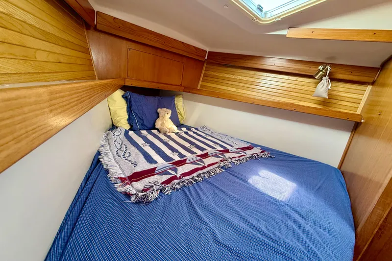 Slide: The Image of Cozy cabin interior of 2002 Catalina 400 MkII sailboat with bed and wooden accents. - 40