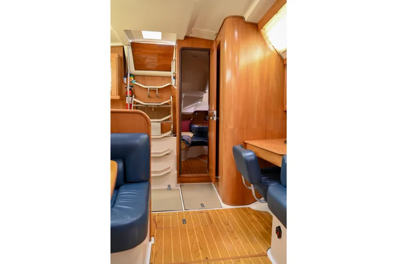 Slide: The Image of Interior of 2002 Catalina 400 MkII sailboat with wood paneling and blue seating. - 7