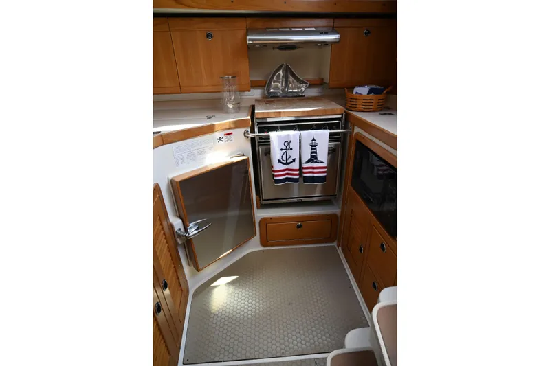 Slide: The Image of Cozy galley kitchen in 2002 Catalina 400 MkII sailboat with nautical-themed decor. - 8
