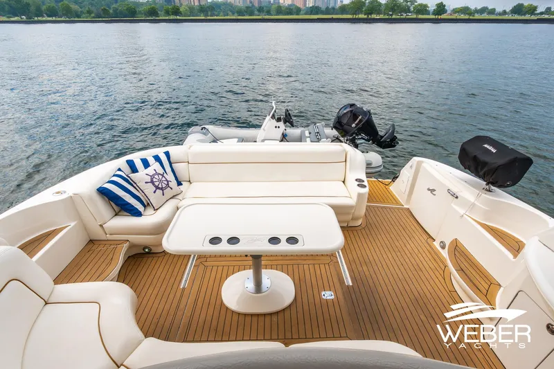 Slide: The Image of Luxurious 2000 Sea Ray Sundancer 460 yacht deck with elegant seating and scenic waterfront view. - 5