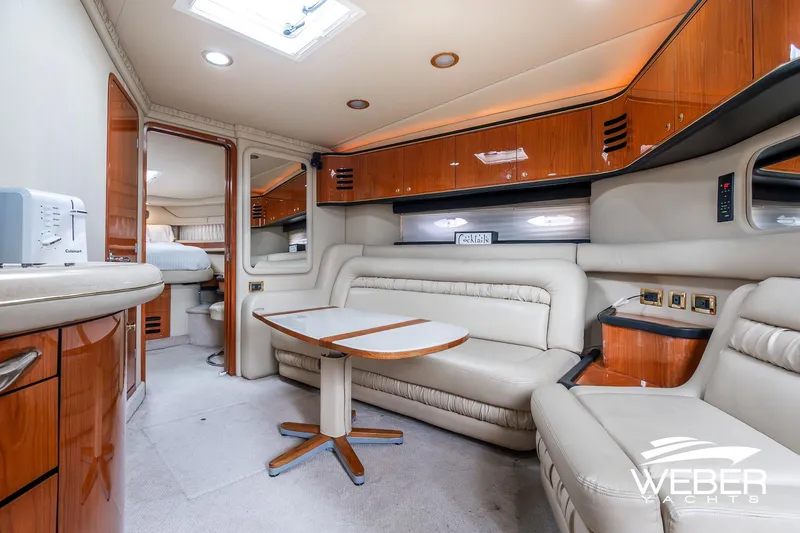 Slide: The Image of Luxurious interior of 2000 Sea Ray Sundancer 460 yacht with plush seating and wood finishes. - 17