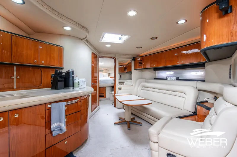 Slide: The Image of Luxurious interior of 2000 Sea Ray Sundancer 460 yacht with elegant wood cabinetry and plush seating. - 25