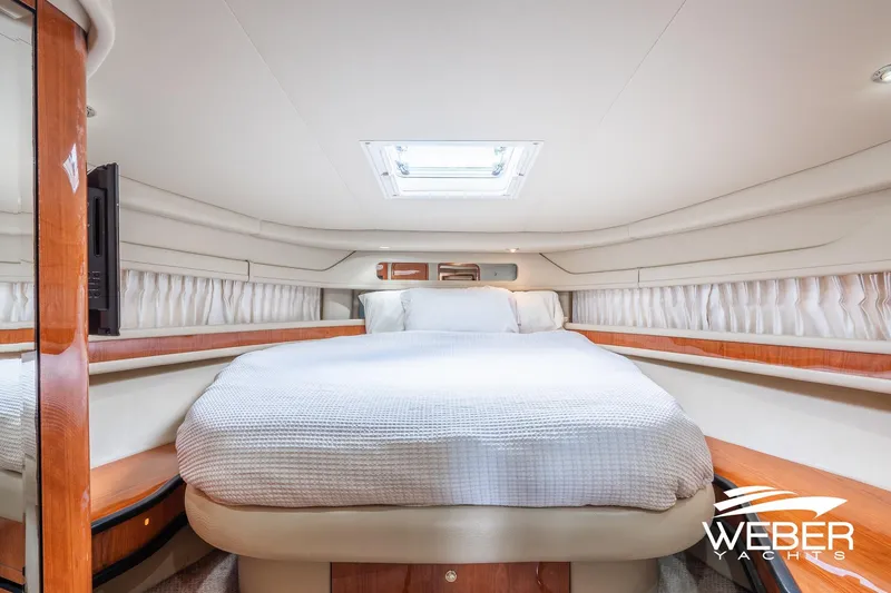 Slide: The Image of Luxurious interior cabin of 2000 Sea Ray Sundancer 460 yacht with cozy bed and elegant design. - 23