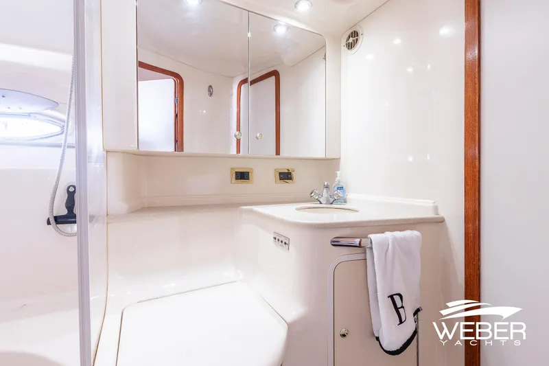 Slide: The Image of Bathroom interior of 2000 Sea Ray Sundancer 460 yacht, featuring sink and mirror. - 29
