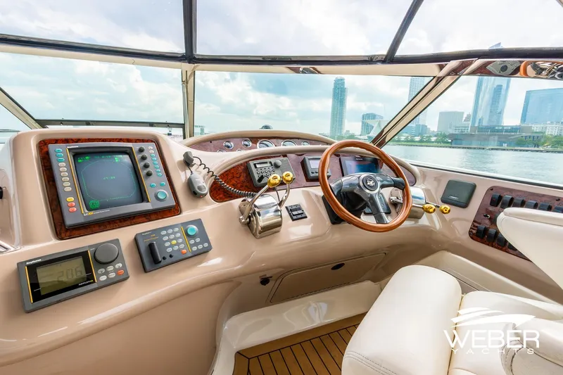 Slide: The Image of Helm of 2000 Sea Ray Sundancer 460 yacht with city skyline view. - 12