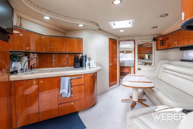 Slide: The Image of Interior of 2000 Sea Ray Sundancer 460 yacht with modern kitchen and seating area. - 16