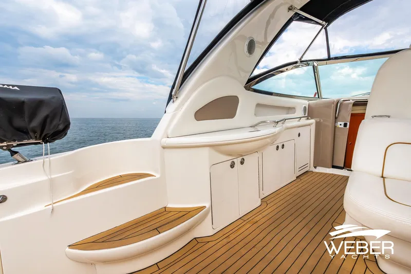 Slide: The Image of Interior view of 2000 Sea Ray Sundancer 460 yacht with teak flooring and ocean backdrop. - 7