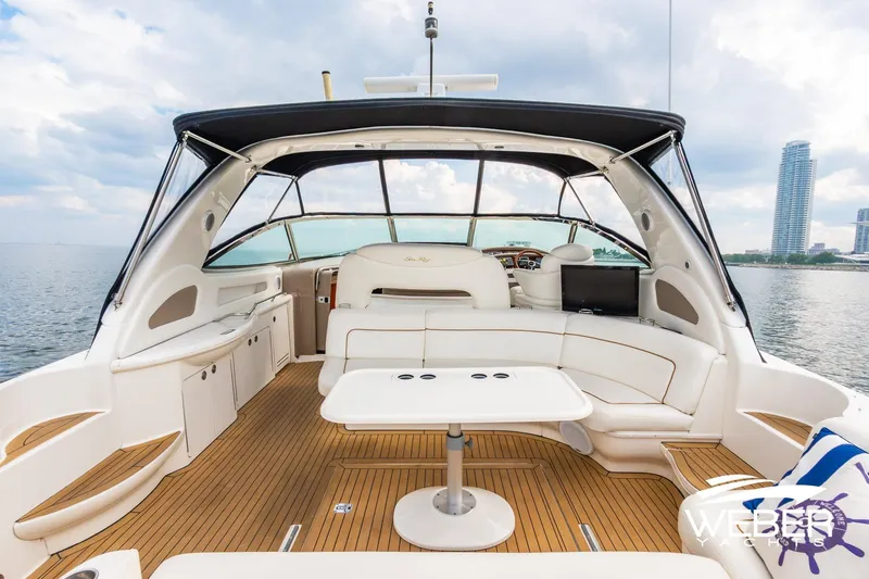 Slide: The Image of Luxurious 2000 Sea Ray Sundancer 460 yacht interior with elegant seating and scenic waterfront view. - 10