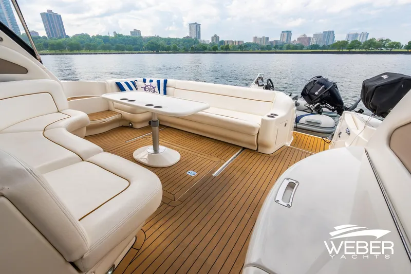 Slide: The Image of Luxurious 2000 Sea Ray Sundancer 460 yacht interior with elegant seating and scenic waterfront view. - 6