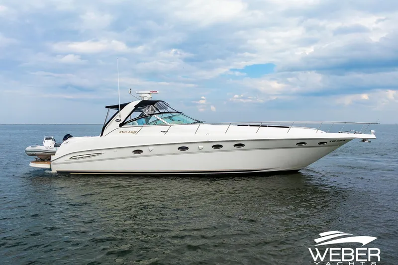 Slide: The Image of 2000 Sea Ray Sundancer 460 yacht on open water under cloudy sky. - 38