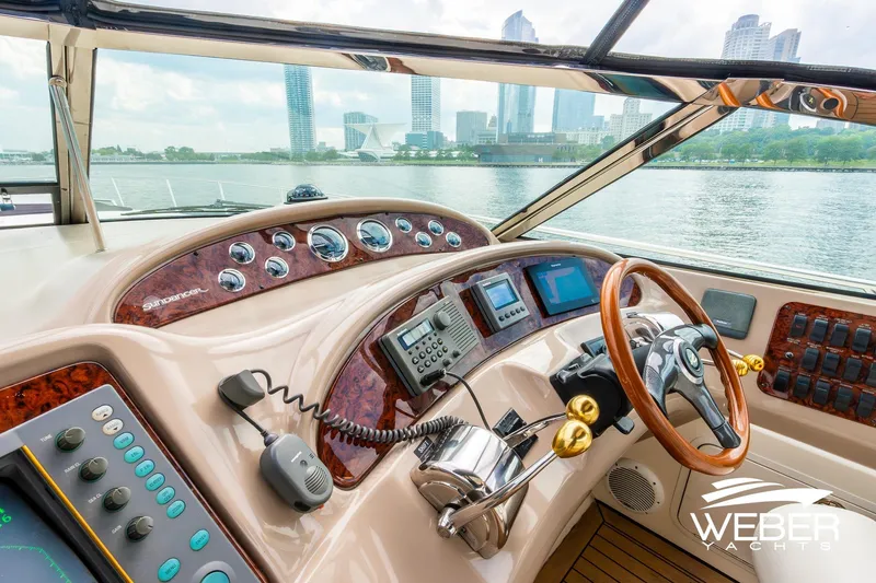 Slide: The Image of Cockpit view of 2000 Sea Ray Sundancer 460 yacht with city skyline in background. - 15