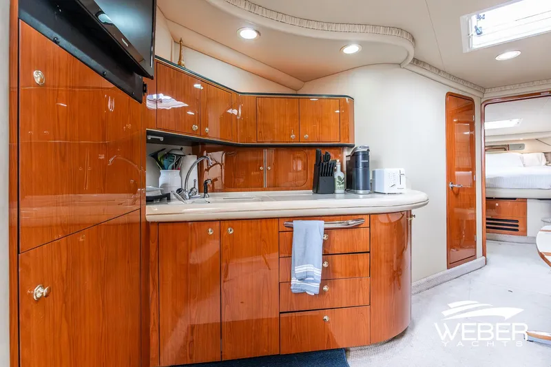 Slide: The Image of Luxurious interior of 2000 Sea Ray Sundancer 460 yacht with modern kitchen amenities. - 21