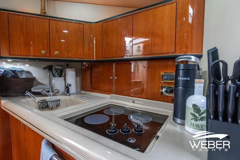 Slide: The Image of Luxurious kitchen area in a 2000 Sea Ray Sundancer 460 yacht with modern amenities. - 24