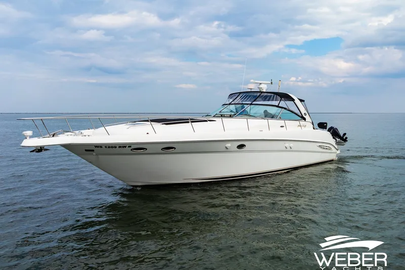 Slide: The Image of Sea Ray Sundancer 460 yacht from 2000 cruising on open water under a cloudy sky. - 36