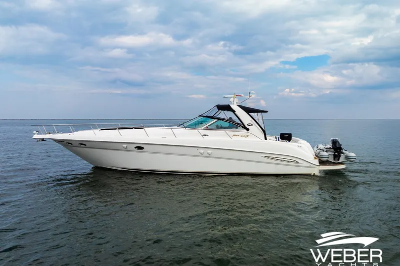 Slide: The Image of Sea Ray Sundancer 460 yacht from 2000 on calm waters under a cloudy sky. - 35