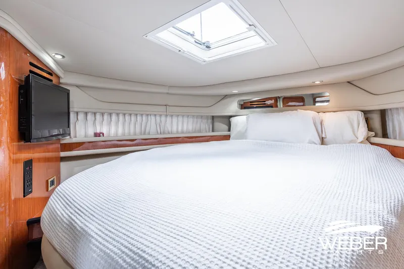 Slide: The Image of Luxurious cabin interior of 2000 Sea Ray Sundancer 460 yacht with cozy bedding. - 27