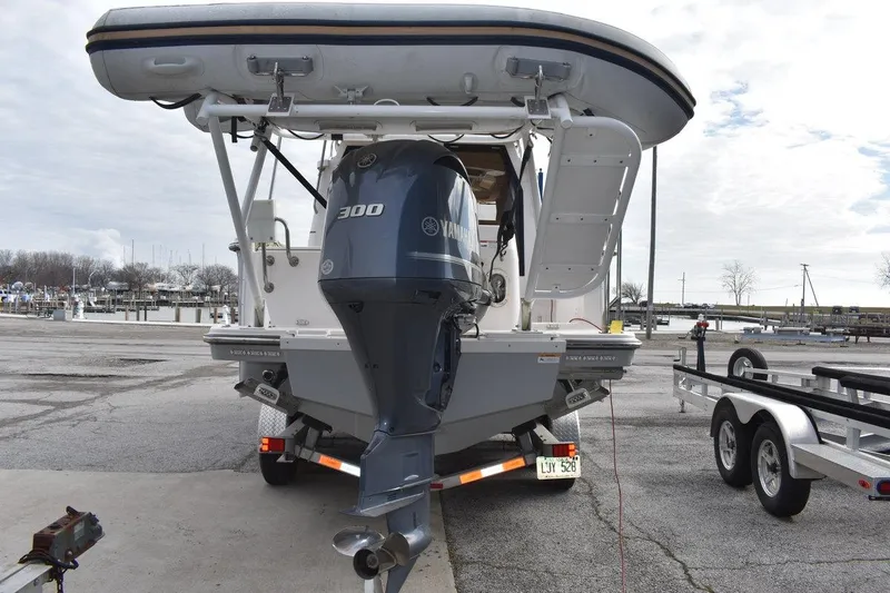 Slide: The Image of Rear view of a 2021 Ranger Tugs R-27 with Yamaha 300 outboard motor at a marina. - 10