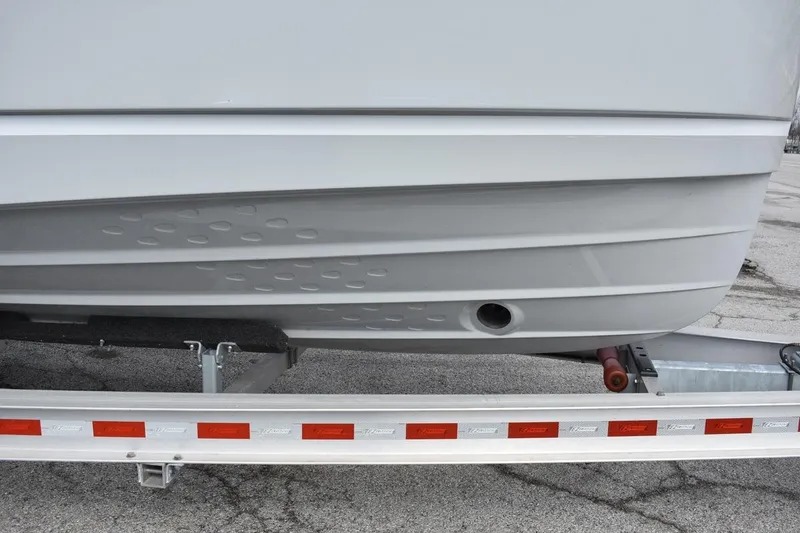 Slide: The Image of 2021 Ranger Tugs R-27 boat hull on trailer, showcasing design details. - 14