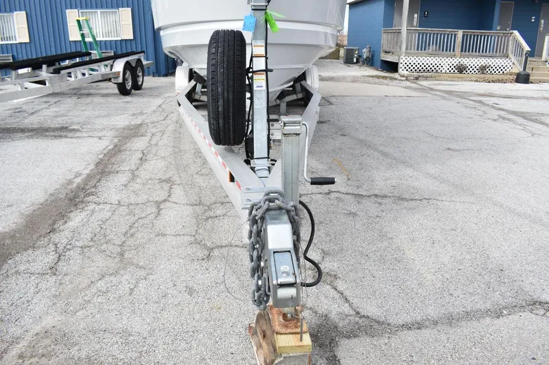 Slide: The Image of 2021 Ranger Tugs R-27 boat trailer with spare tire in a parking lot. - 16