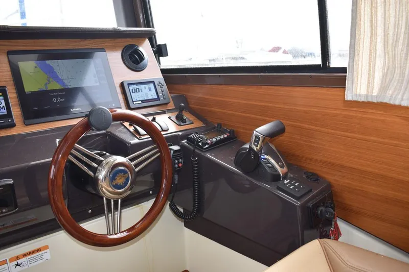Slide: The Image of Interior helm of 2021 Ranger Tugs R-27 with navigation equipment and steering wheel. - 18