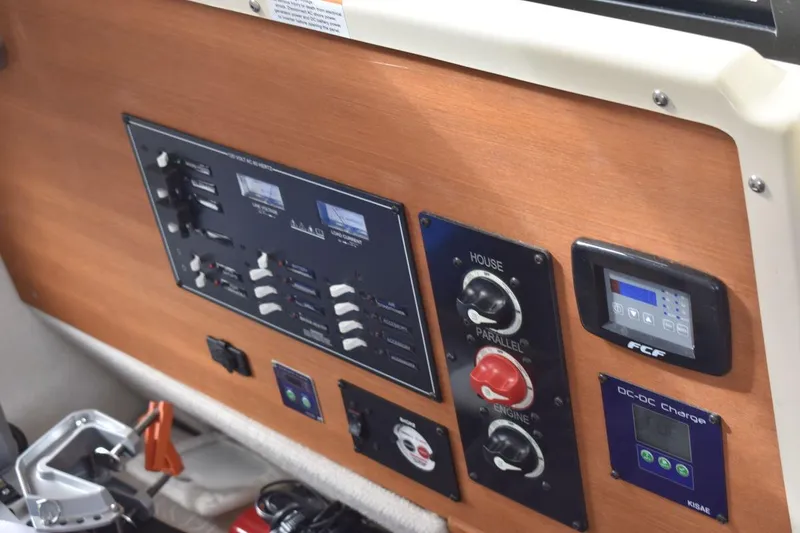 Slide: The Image of Control panel of a 2021 Ranger Tugs R-27 boat with various switches and displays. - 20