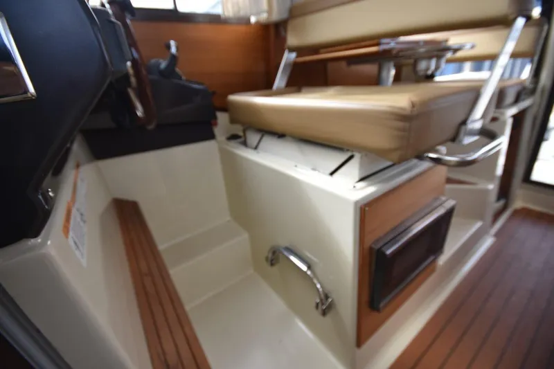 Slide: The Image of Interior of 2021 Ranger Tugs R-27 boat with seating and wooden flooring. - 29