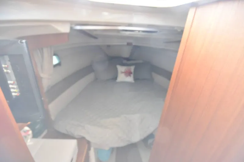 Slide: The Image of Cozy cabin interior of 2021 Ranger Tugs R-27 with bed and nautical decor. - 31