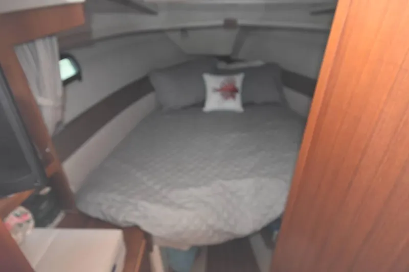 Slide: The Image of Cozy cabin interior of 2021 Ranger Tugs R-27 with a neatly made bed. - 32