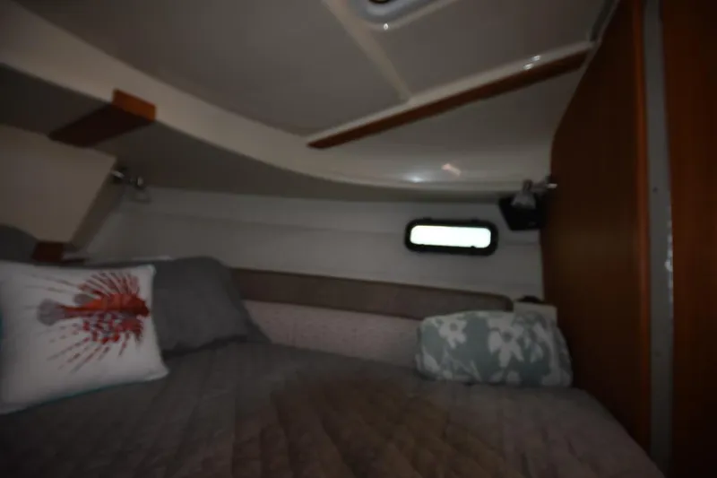 Slide: The Image of Cozy cabin interior of 2021 Ranger Tugs R-27 with decorative pillows and bedding. - 34