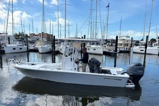 The Image of 2022 Sportsman Masters 227 Bay Boat docked in a marina with other vessels. - 0