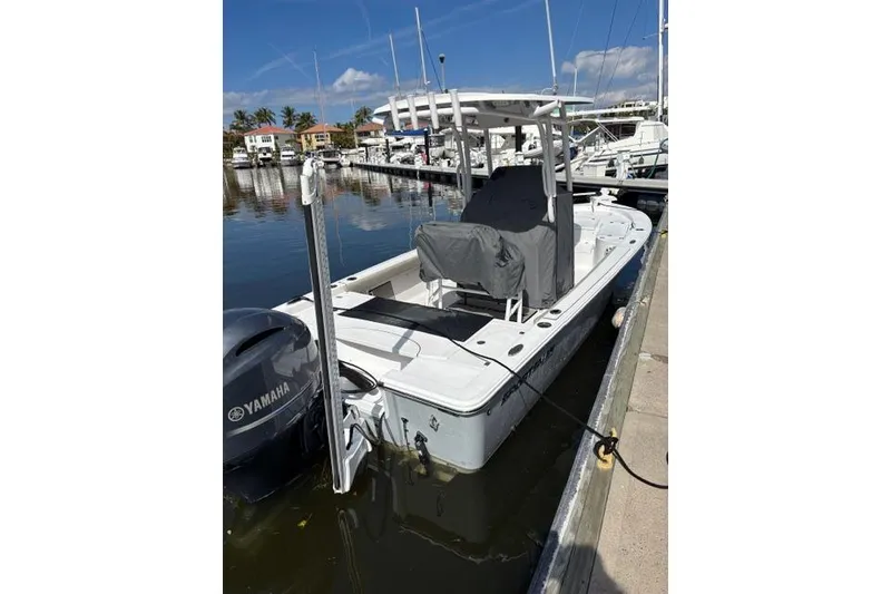 Slide: The Image of 2022 Sportsman Masters 227 Bay Boat docked with Yamaha engine, clear sky background. - 14